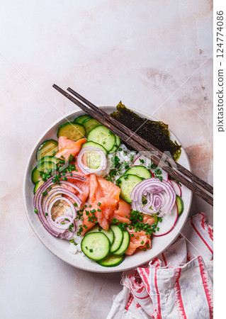 Salmon sushi salad with rice, vegetables and nori. Salmon sushi salad with rice, vegetables and nori. 124774086