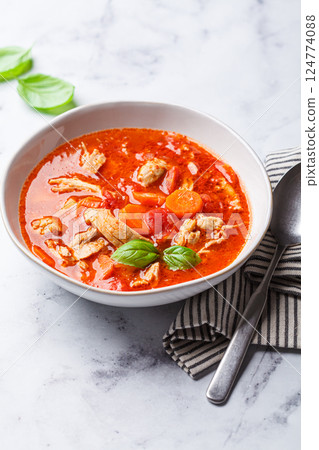Tomato chicken soup with vegetables and basil. Tomato chicken soup with vegetables and basil. 124774088
