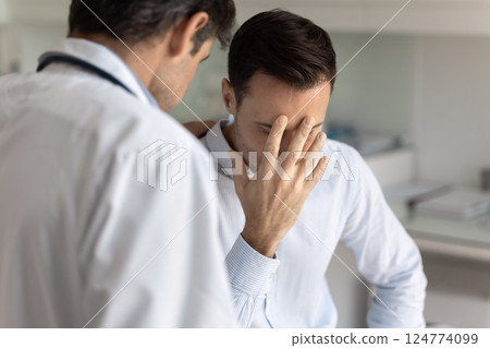 Doctor put hand on sad patients shoulder, close up 124774099