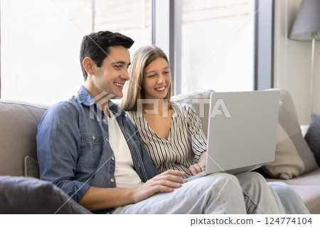 Beautiful young couple do online shopping using laptop Beautiful young couple do online shopping using laptop 124774104