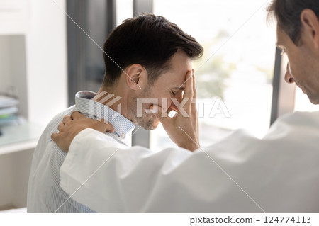 Doctor speaks with patient, explain difficult treatment, touch his shoulder Doctor speaks with patient, explain difficult treatment, touch his shoulder 124774113
