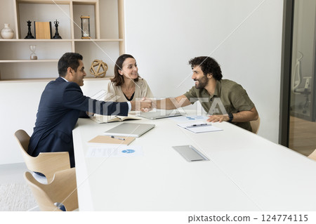 Businesspeople finish negotiation, formal meeting with handshake Businesspeople finish negotiation, formal meeting with handshake 124774115