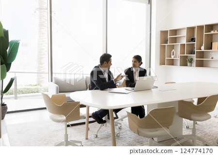 In modern conference room workmates working on common task completion In modern conference room workmates working on common task completion 124774170