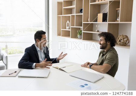 Client and manager engaged in negotiation or discussion in office Client and manager engaged in negotiation or discussion in office 124774188