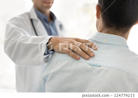 Close up shot of unknown doctors hand on patients shoulder Close up shot of unknown doctors hand on patients shoulder 124774215