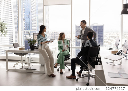 Small business team discussing teamwork in city office space Small business team discussing teamwork in city office space 124774217