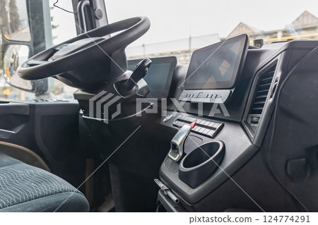 Lower angle closeup view of  empty cabin of a  truck. 124774291