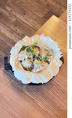 Caucasian cuisine - khinkali with meat, spectacular presentation of the dish. Kenza. 124774352