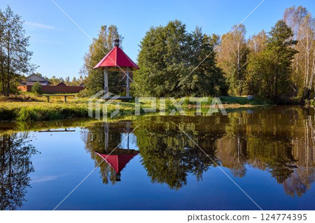 Tranquil Waterfront Gazebo on Sunny Day Tranquil Waterfront Gazebo on Sunny Day 124774395