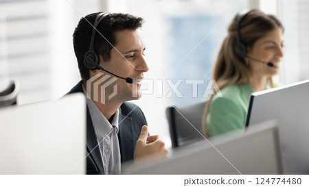 Positive Hispanic telephone support employee man speaking to customer Positive Hispanic telephone support employee man speaking to customer 124774480