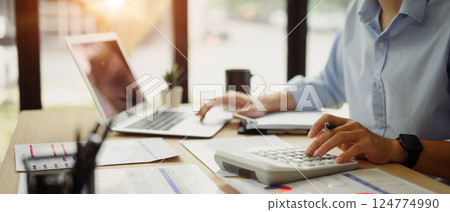 Businessman calculating finances at office desk. Concepts of finance management 124774990