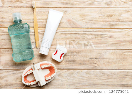 Mouthwash and other oral hygiene products on colored table top view with copy space. Flat lay. Dental hygiene. Oral care kit. Dentist concept Mouthwash and other oral hygiene products on colored table top view with copy space. Flat lay. Dental hygiene. Oral care kit. Dentist concept 124775041