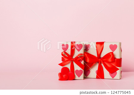 gift box with red bow and red heart on colored background. Perspective view. Flat lay 124775045