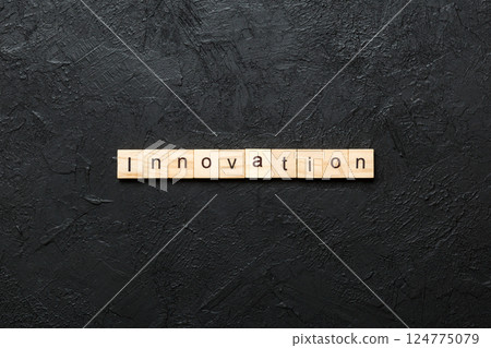 INNOVATION word written on wood block. INNOVATION text on table, concept INNOVATION word written on wood block. INNOVATION text on table, concept 124775079