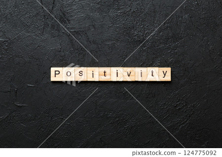 positivity word written on wood block. positivity text on cement table for your desing, concept 124775092