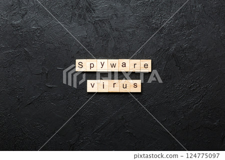Spyware virus word written on wood block. Spyware virus text on cement table for your desing, concept 124775097