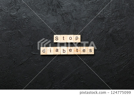 Stop diabetes word written on wood block. Stop diabetes text on cement table for your desing, Top view concept 124775099