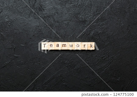 TEAMWORK word written on wood block. TEAMWORK text on cement table for your desing, concept TEAMWORK word written on wood block. TEAMWORK text on cement table for your desing, concept 124775100