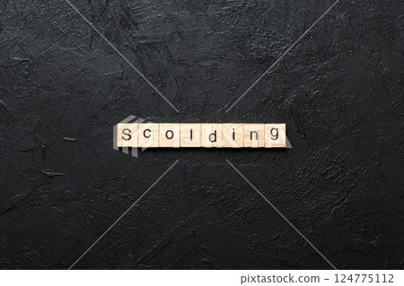 scolding word written on wood block. scolding text on table, concept 124775112
