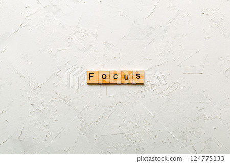 focus word written on wood block. focus text on table, concept 124775133