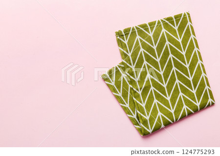 top view with green kitchen napkin isolated on table background. Folded cloth for mockup with copy space, Flat lay. Minimal style 124775293