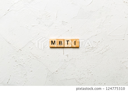 MBTI word written on wood block. Myers-Briggs Type Indicator text on table, concept 124775310