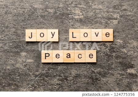 joy love peace word written on wood block. joy love peace text on cement table for your desing, concept joy love peace word written on wood block. joy love peace text on cement table for your desing, concept 124775356