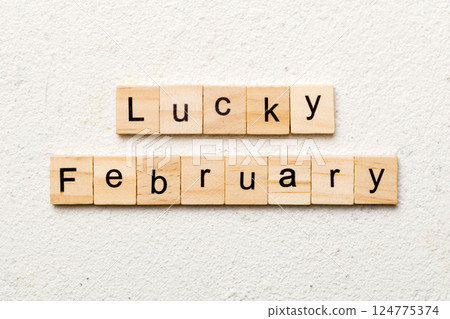 lucky February word written on wood block. lucky February text on table, concept 124775374
