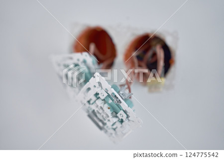 Light switch installation during renovation. Electrical switches with exposed copper wires. Unfinished wall with electrical cables inside plastic socket holders 124775542