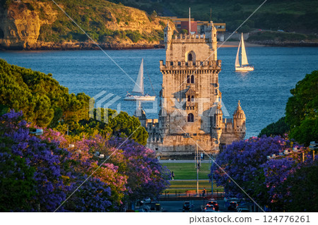 Belem Tower in Lisbon Framed by Blooming Jacaranda Trees and Sailboats on the Tagus River, Portugal Belem Tower in Lisbon Framed by Blooming Jacaranda Trees and Sailboats on the Tagus River, Portugal 124776261