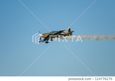 Stunt aerobatic plane performing stunts in air Stunt aerobatic plane performing stunts in air 124776270