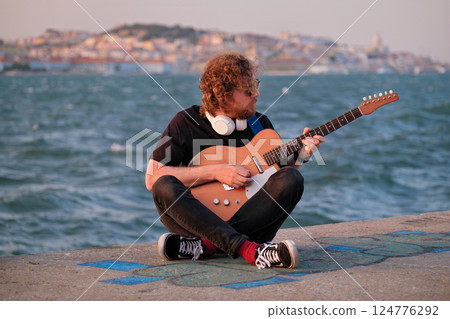 Street musician playing electric guitar in the street Street musician playing electric guitar in the street 124776292