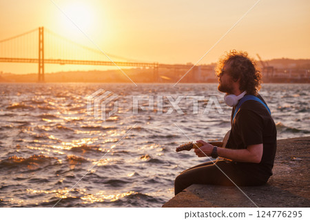 Street musician playing electric guitar in the street Street musician playing electric guitar in the street 124776295