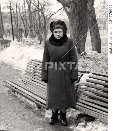 Vintage portrait of a thoughtful young girl dressed in 1950s fashion in the city. Retro photo from 1955. Vintage portrait of a thoughtful young girl dressed in 1950s fashion in the city. Retro photo from 1955. 124776605