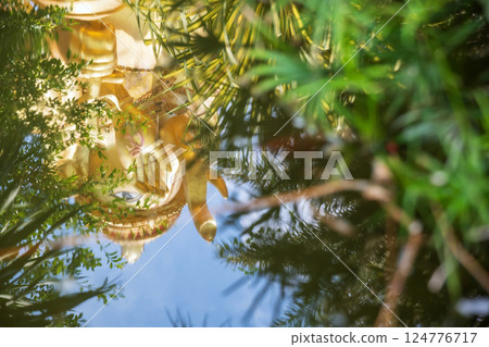 Golden ganecha reflection on water pond at Wat Mae Ya Som 124776717