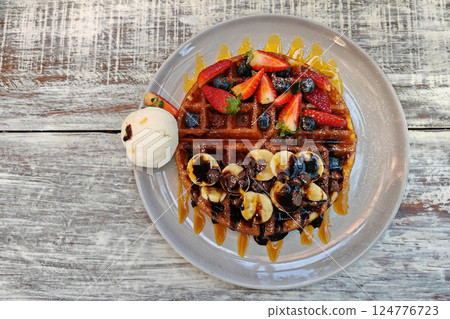 top view dessert of waffles with vanilla ice cream and fruit. 124776723