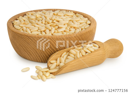 Shelled European pine nuts in wooden bowl and scoop isolated on white background with full depth of field Shelled European pine nuts in wooden bowl and scoop isolated on white background with full depth of field 124777156