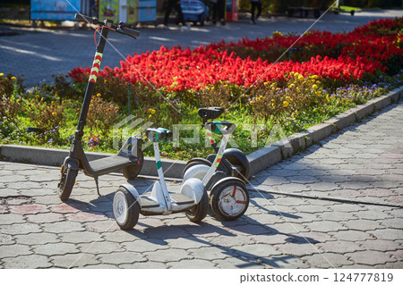 two rental segways and one electro scooter in park 124777819