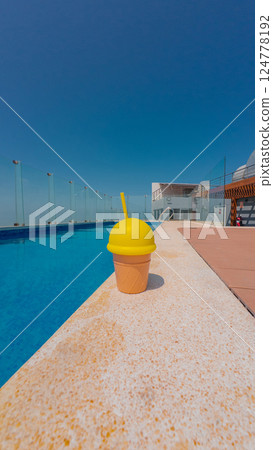 Ice cream cup by the pool on a summer day Ice cream cup by the pool on a summer day 124778192
