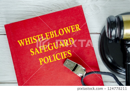 Top view of Whistleblower Safeguard Policies book with whistle and gavel background 124778211