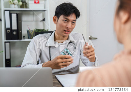 Patient Education and Medication Overview. Doctor elaborating on medication while showing a pill pack. Patient Education and Medication Overview. Doctor elaborating on medication while showing a pill pack. 124778384