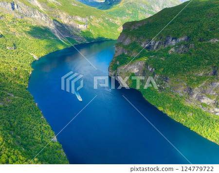Norway. Boat in the Norwegian fjord. High mountains and reflections on the surface of the water. 124779722