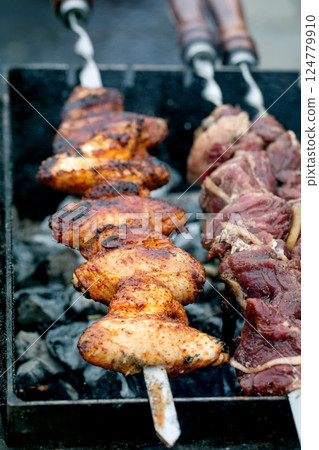 Juicy Meat Skewers Grilling on Barbecue 124779910
