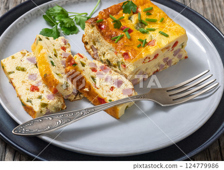 Baked Denver Omelette on a plate with fork Baked Denver Omelette on a plate with fork 124779986