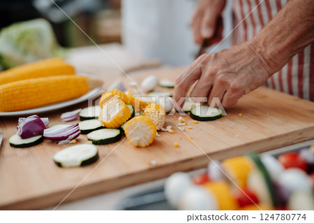 Close up of family preparing food for a spring weekend barbecue. 124780774