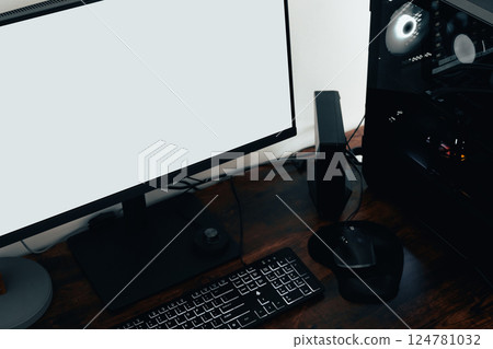 Modern home office with PC workstation for graphic designers, photographers, or video editors. Includes a computer, mouse, and white screen on a sleek brown oak desk Modern home office with PC workstation for graphic designers, photographers, or video editors. Includes a computer, mouse, and white screen on a sleek brown oak desk 124781032