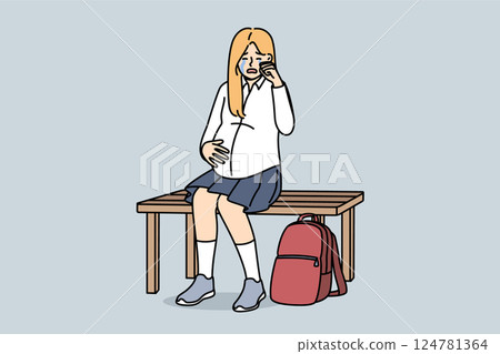 Pregnant schoolgirl is crying, sitting on bench and experiencing stress due to early motherhood 124781364