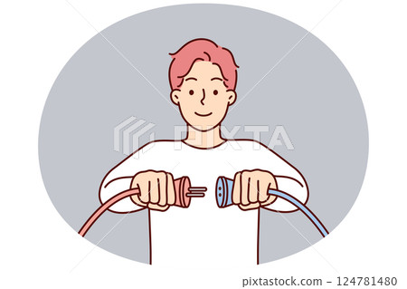 Man holding two cords with high voltage wish to connect wires to start electrical equipment 124781480