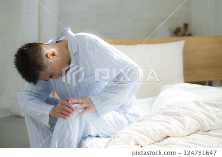Senior man in bed, back pain, joint pain Senior man in bed, back pain, joint pain 124781647