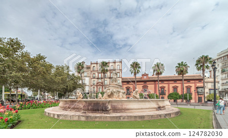 Hispalis Fountain in Seville surrounded by flowers and historical buildings timelapse 124782030